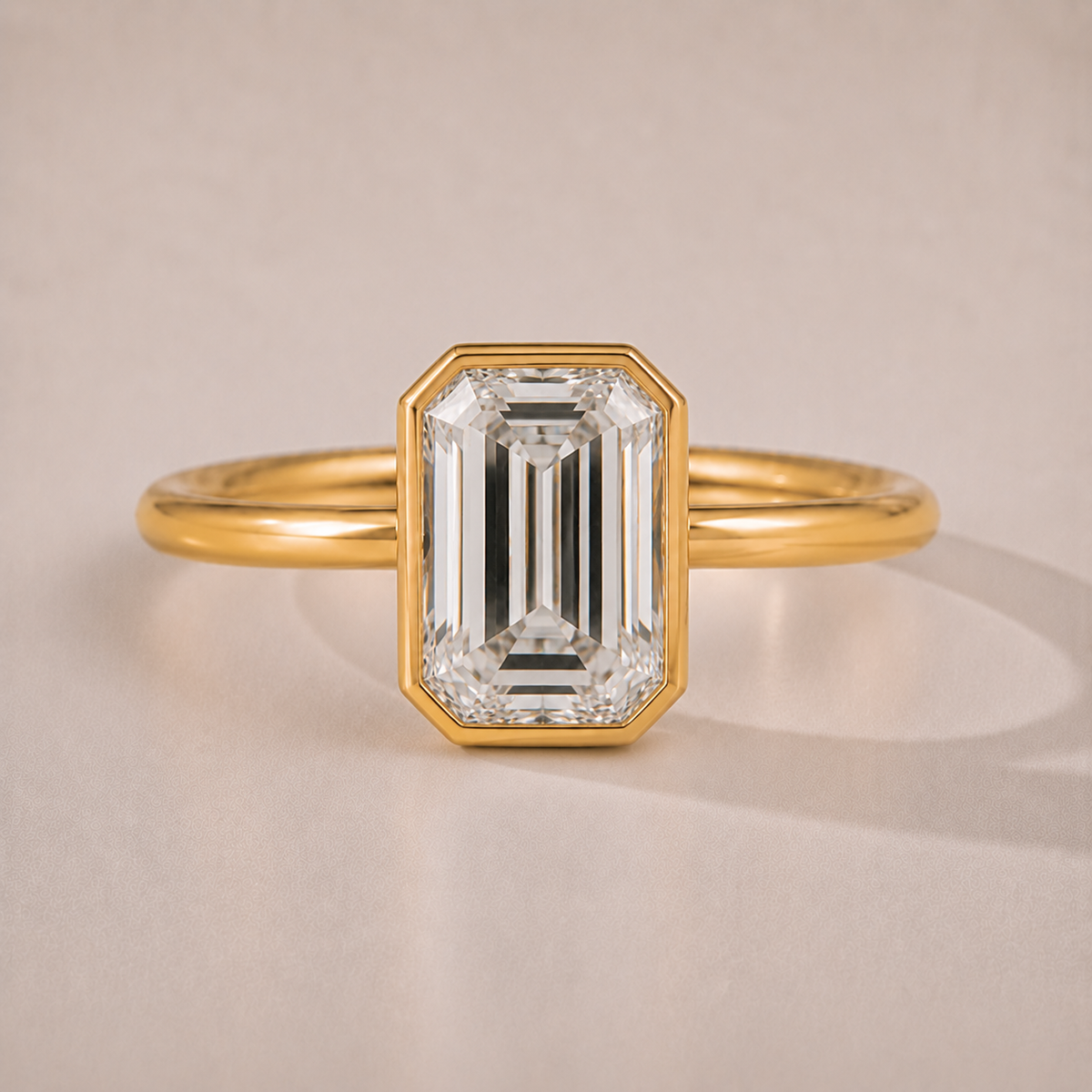 The Ines — emerald-cut bezel-set lab-grown diamond engagement ring in 14K yellow gold